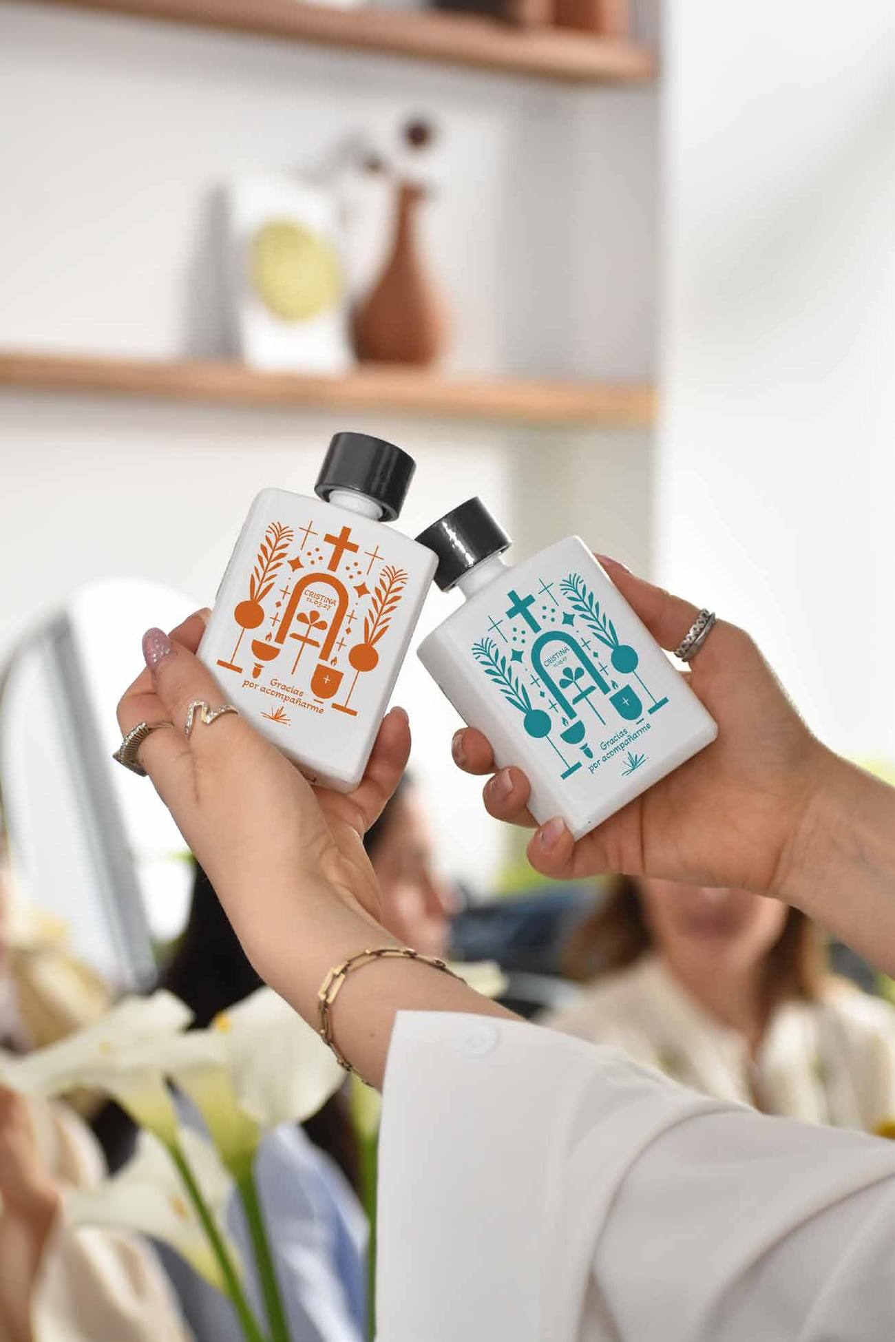 Dos invitadas sosteniendo botellas Pocket con ilustraciones a color